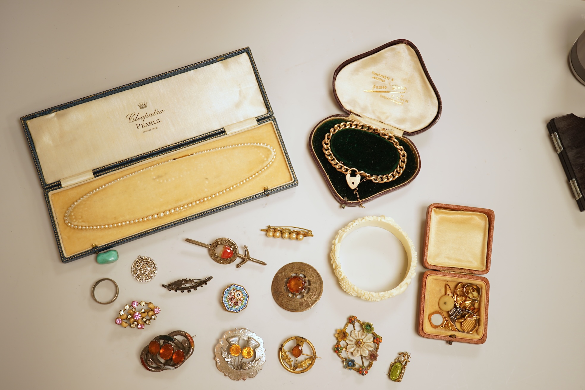 A small group of assorted jewellery including a gold plated curb link bracelet, silver brooch, simulated pearl necklace and costume.